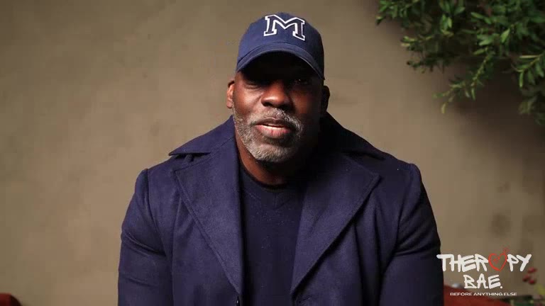 A participant in a blue cap speaking on camera
